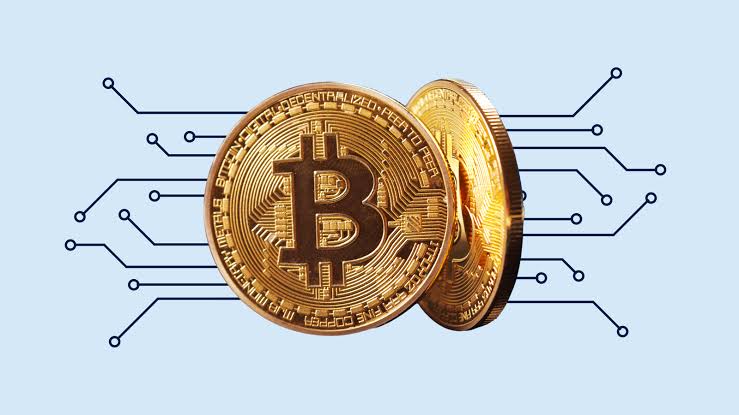 Cryptocurrency coins sit on a keyboard.